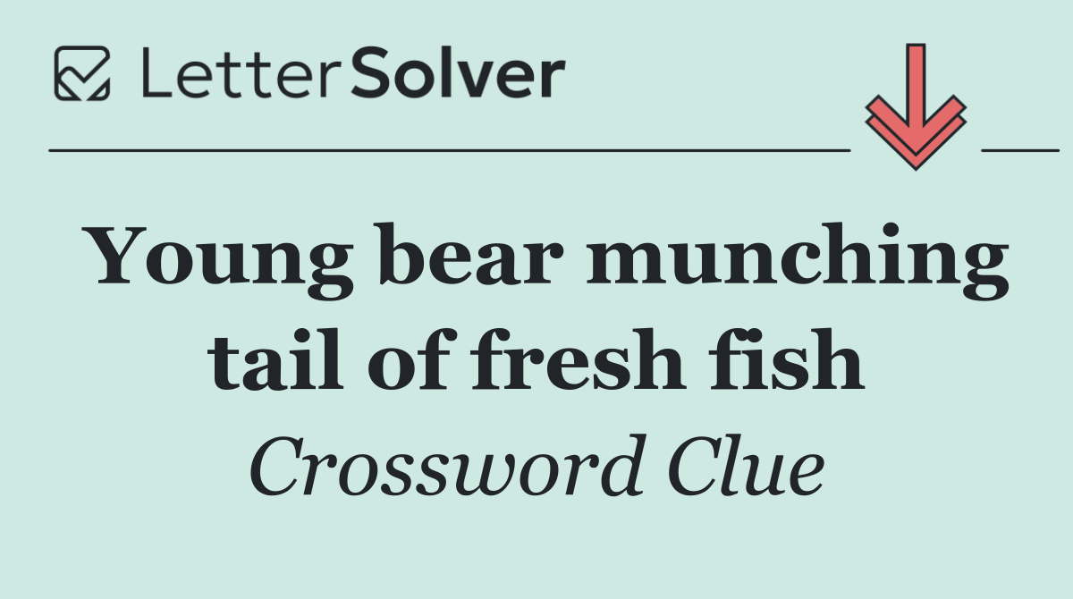 Young bear munching tail of fresh fish