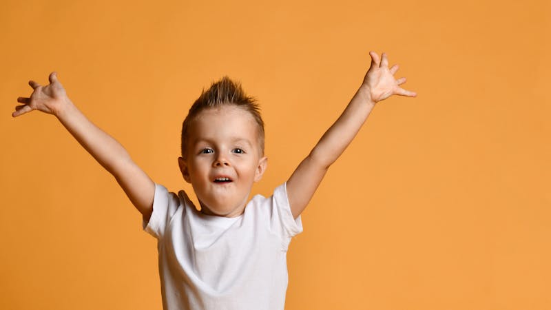 child with arms up