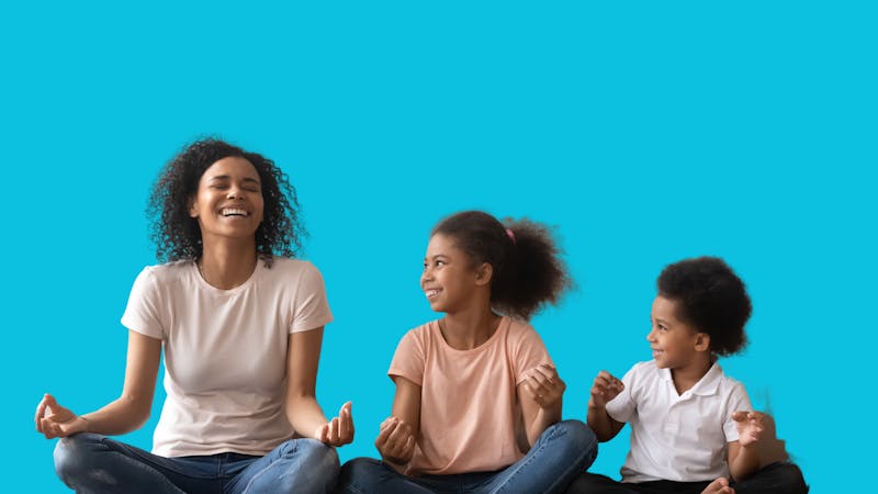 mother and two kids meditating